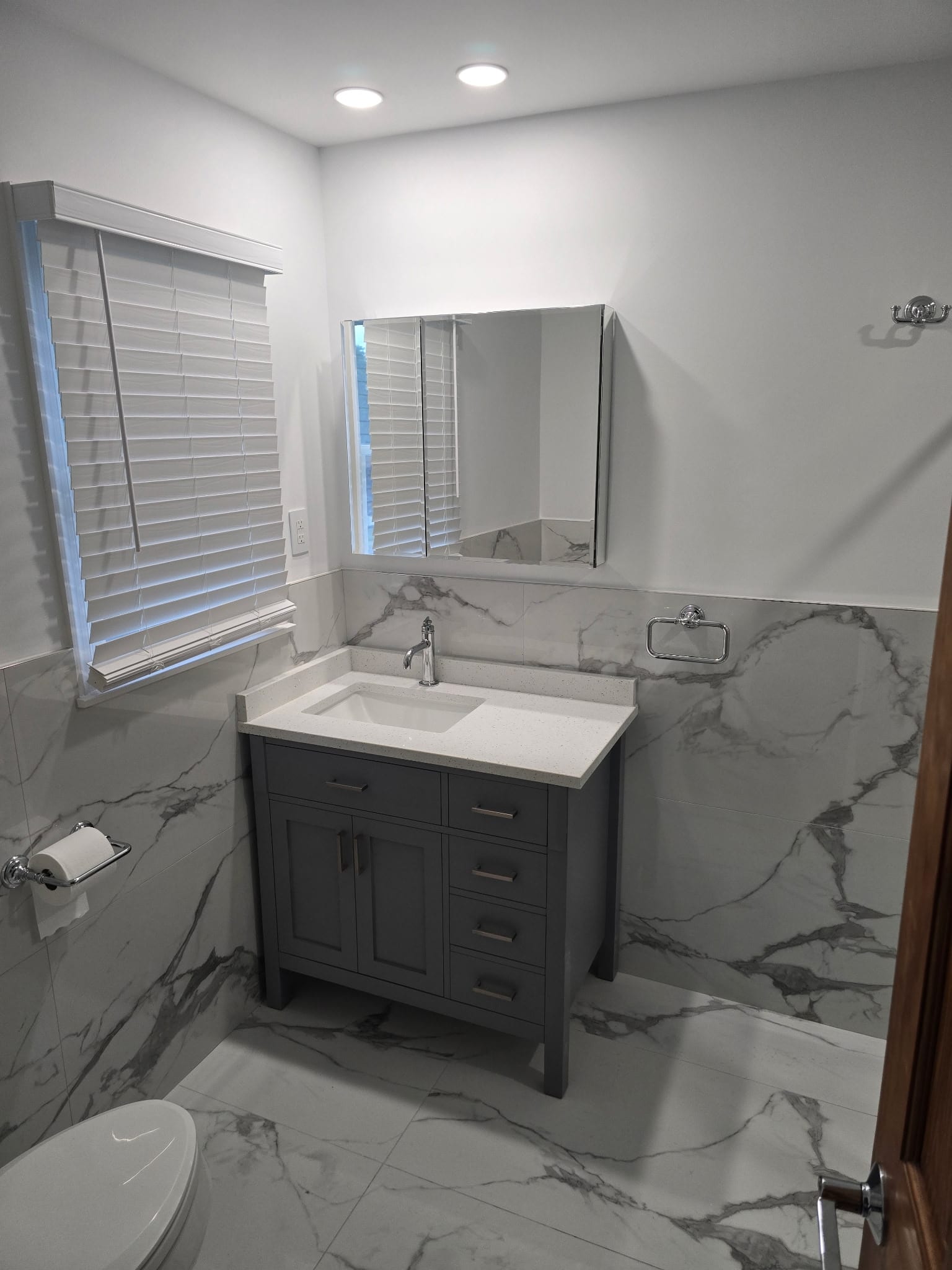 Vanity area with marble walls
