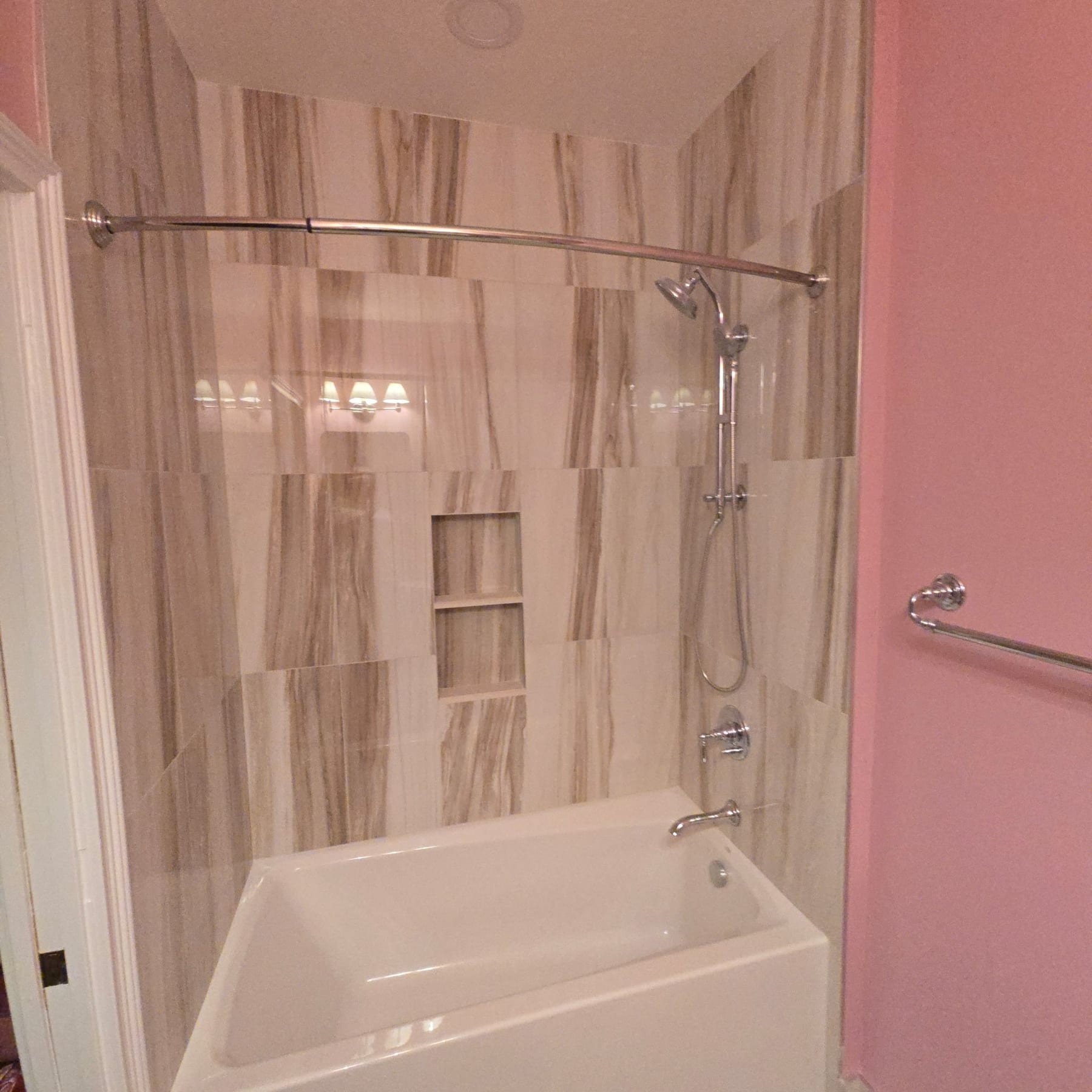 Vertical stone-tile shower with rose-pink walls